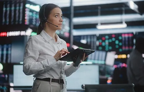Investment professional reviewing market information on a tablet